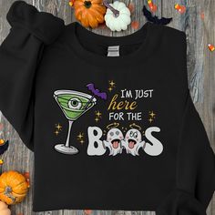 This funny Halloween t-shirt is perfect for your next Halloween party! Featuring a quirky "I'm Just Here For The Boos" design with cute ghosts and a spooky cocktail, this shirt is sure to get laughs. Perfect for fans of Halloween puns and those who love a good party, this tee is comfortable and perfect for any Halloween outing. Grab yours today and get into the Halloween spirit! **AVAILABLE AS T-SHIRTS & SWEATSHIRTS** UNISEX T-SHIRT: Experience the epitome of comfort and classic style with our U Halloween Party Tops With Letter Print, Halloween Party Letter Print Tops, Funny Halloween Tops With Text, Halloween Novelty Tops With Funny Text, Halloween Crew Neck Top With Funny Text, Casual Halloween Slogan T-shirt, Funny Orange Halloween T-shirt, Halloween Puns, Funny Halloween T-shirt With Short Sleeves