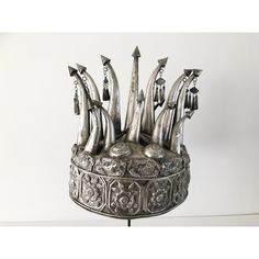 This exquisite vintage crown is a bridal headdress from the Chinese Miao Tribe. Decorated with hand crafted repousse fish and flower motifs. The dangling bells are a festive touch when the bride walks and dances as they make pleasant sounds with movement.    Mounted on a custom painted iron stand, it makes a spectacular display. This item is not "sterling silver", but it is a silver alloy that can be polished.   "Because the Miao silverware producing regions have no natural silver resources, the Bohemian Round Crown Headpiece For Wedding, Bohemian Wedding Headpiece With Round Crown, Ceremonial Headpiece With Tall Crown, Bohemian Crown For Festival With Structured Shape, Adjustable Tall Crown Headpiece For Ceremonial Occasions, Unique Wedding Crown Headpiece, Adjustable Ceremonial Headpiece With Pinched Crown, Traditional Tall Crown Headpiece For Festivals, Traditional Tall Crown Festival Headpieces