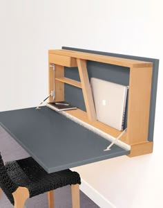 a computer desk with a laptop on it