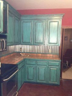 an image of a kitchen with blue cabinets