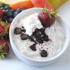 a white bowl filled with pudding next to fruit