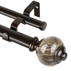 a curtain rod with a marble ball on it and a black metal pole attached to it