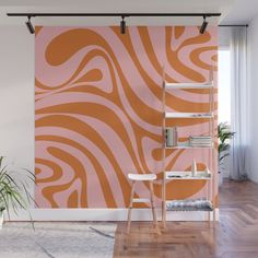 an orange and pink wall mural in a living room