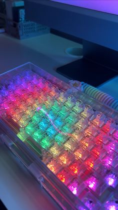 a computer keyboard with many colored lights on it's backlit keyshells