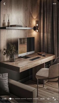 a computer desk with a monitor and keyboard on it in front of a wall mounted shelf