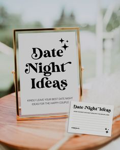 a sign that says date night ideas next to a table with a notepad on it