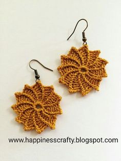 a pair of crocheted earrings with dangling hooks