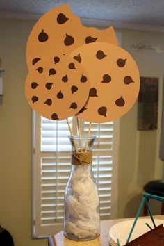 two vases with paper hearts in them sitting on a table