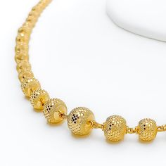 This 22k gold necklace, weighing 20.6 grams, features a stunning Graduated Disco Orb design that captures and reflects light, mimicking the sparkling allure of a disco ball. The yellow gold finish enhances the necklace's vibrancy and charm. Measuring 16 inches in length with an additional 0.5 inches of adjustable links, it offers both a comfortable fit and versatile styling options. The secure combination of a hook lock with a clasp ensures that this dazzling piece remains securely in place, per Traditional Yellow Gold Diamond Cut Necklaces, Traditional Yellow Gold Diamond-cut Necklace, Traditional Yellow Gold Diamond Cut Necklace, Yellow Gold Round Pendant Necklace For Festive Occasions, 22k Yellow Gold Round Beads Necklace, Gold Necklace With Diamond-cut Round Beads, Gold Diamond-cut Necklace With Round Beads, Gold Diamond Cut Necklace With Round Beads, 22k Gold Necklace