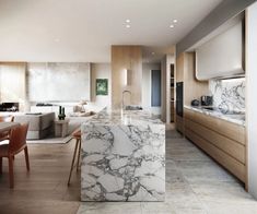 a kitchen with marble counter tops next to a dining room and living room area in the background