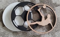 two soccer balls on top of each other with a black and white ball in the middle