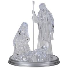 a glass figurine with a manger scene on the base and a baby jesus