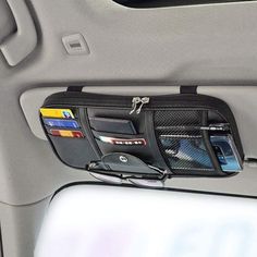 the inside of a car with wallets and other items hanging from it's pockets