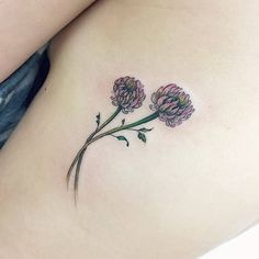 a woman's stomach with three flowers on it