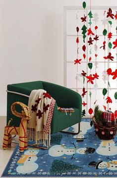 a living room filled with furniture and decorations on top of a blue rug covered in snowflakes