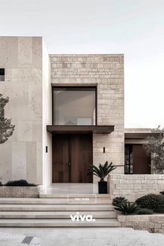 a modern house with stairs leading to the front door