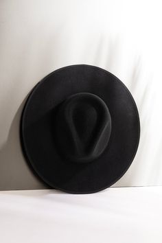 Copy     Details:  100-percent Australian wool Crown 4" Brim (firm) 3 and 7/8" Hidden adjustable band for fit flexibility Size guide Return policy Black Wool Felt Hat With Flat Crown, Black Felt Hat With Flat Crown For Winter, Chic Black Fedora With Flat Crown, Black Fedora With Curved Brim, Black Wool Fedora With Curved Brim, Black Wool Fedora With Flat Crown, Western Black Boater Hat With Curved Brim, Black Western Boater Hat With Curved Brim, Black Western Boater Hat With Wide Brim