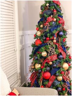 a christmas tree decorated with red, blue and gold ornaments