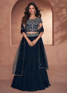 "Give in to the exotic confluence of today and tomorrow in this beautiful attire. You are sure to make a strong fashion statement with this blue silk readymade lehenga choli. This attire is beautifully adorned with embroidered and resham work. Comes with matching choli and dupatta. " Fancy Crop Top, Indo Western Lehenga, Lehenga Crop Top, Crop Top Lehenga, Resham Work, Party Wear Lehenga Choli, Salwar Dress, Dress Salwar Kameez, Lehenga Online