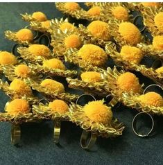 yellow pom - poms are arranged in rows on a table with two pairs of scissors