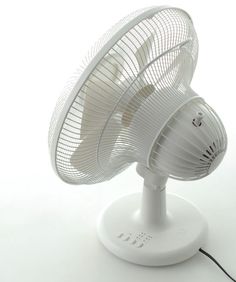 an electric fan sitting on top of a white table