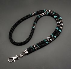 Discover this handmade black beaded teacher lanyard in a Native American style. A stylish badge holder, perfect gift for educators, combining beauty and functionality. **Elegant and Practical Design**   - Beautiful black beaded lanyard adds style to any teacher's outfit.   - Durable design ensures it withstands everyday classroom use.   - Perfect for holding work ID badges securely and stylishly. **Meaningful Native American Influence**   - Intricate beadwork inspired by Native American craftsma Native Beaded Lanyards, Native American Beaded Necklace, Beaded Lanyard, Beadwork Necklace, Teacher Lanyard, Native American Style, Beaded Lanyards, Native American Beading, Native American Fashion