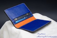 This wallet is unique, you will never see the exact same thing. The exterior alligator leather is cut along its scale's edge to show an orange layer below. The orange line is unique because the texture of the alligator is unique. The wallet opens vibrantly with blue and orange color inside. I've tried my best to put my unique technique and my passion into this small piece. Every single wallet is made to order, there won't be a second same thing. If you are looking for a small accessory but it's Blue Leather Card Holder For Formal Use, Luxury Blue Leather Card Holder, Blue Business Card Holder With Interior Slots, Business Blue Card Holder With Interior Slots, Blue Leather Card Holder With Interior Slots, Blue Leather Business Card Holder, Elegant Blue Bifold Card Holder, Blue Bifold Card Holder With Interior Slots, Blue Bifold Card Holder For Formal Occasions