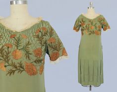 1920s sage green medium weight silk dress with fabulous details. This piece features the classic straight cut flapper silhouette, with a light and easy fit. Neckline and short sleeves are trimmed in ecru silk mesh, while the entire yoke of the bodice including sleeves is covered in dense crewel embroidered flowers and trailing leaves in varied shades of golds, browns, and greens, nestled amidst a green and gold embroidered web design. The skirt is accented in hanging silk panels that sway with movement - a design now known as a car wash hem -sometimes seen on pieces of the era. There are hidden snaps down the left side for ease. Such a special, playful and at the same time elegant piece. LAYAWAY is available for all items, please message me for details. Measurements: Meant to fit loosely R 1920s Day Dress, 1920 Dress, 20s Dresses, Sage Green Dress, Sheer Lace Top, 20s Fashion, 1920s Dress, Lancaster Pa, 1920s Fashion