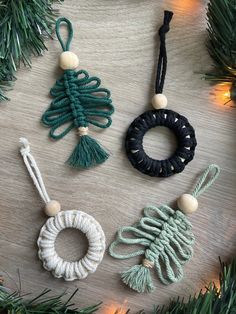 three ornaments are hanging from a christmas tree