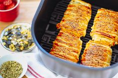 some food is cooking in a pan on the table