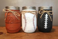 three mason jars with baseball, basketball and softball painted on them