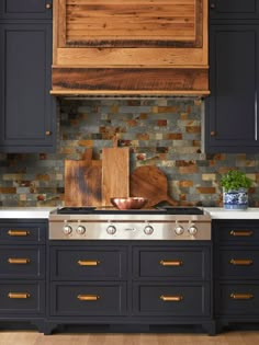 a stove top oven sitting inside of a kitchen next to wooden counter tops and cabinets