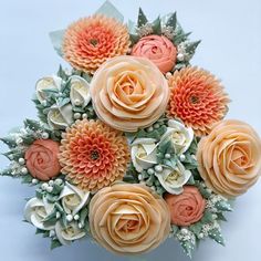 a bridal bouquet with peach and white flowers