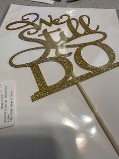 there is a cake topper that has the word's name on it and an arrow sticking out of it