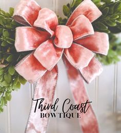 a pink bow with green leaves on the front and back of it, that says third coast bow tour