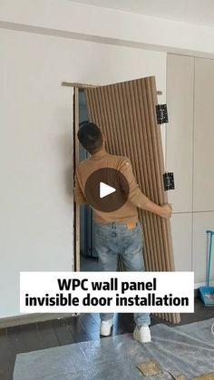 a man standing in front of a wall that is being installed