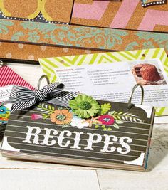 a recipe book with a bow on it sitting in front of a wall and door