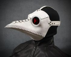 "This mask is identical to our popular plague doctor mask Schnabel, but made to accommodate eyeglasses. It measures about 12\" long not counting the straps. The leather mask is mostly riveted together with some hand-stitching and some metal leather staples. The eyepieces are hand sewn in with waxed thread. The mask comes in white with red lenses. It is made of medium weight veg tanned leather and has an adjustable strap. It comes with two series of ventilation holes on the top and bottom of the White Plague Doctor, Plague Dr Mask, Plague Dr, Steampunk Plague Doctor, Beak Mask, Plague Doctor Costume, Plague Mask, Steampunk Mask, Plague Doctor Mask