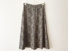 "Vintage Animal print midi skirt, a-line women's skirt, lightweight leopard print skirt, beige black cheetah print women skirt, gift idea for her Measurements: Waist: 29.5\" Hips: 41\" Length: 33\" Please check measurements to insure a proper fit. Remember to allow yourself some extra room for movement. You can compare these with something from your closet that fits you well. Condition: Good vintage condition SHIPPING * I ship worldwide via Priority mail (Latvijas Pasts) from Latvia (EU). * I ship from Europe, so please allow 2 to 4 weeks for the package to arrive if you live overseas. * Europe 5 - 10 business days. Go back to my shop: YourEclecticStreet.etsy.com P.S. why buy Vintage? - Vintage is Unique! - Vintage is Eco Friendly! - Vintage is Inspirational! - Vintage is History! - Vintag Fitted Long Skirt In Leopard Print, Summer Leopard Print Lined Skirt, Chic Leopard Print Skirt For Spring, Chic Flowy Leopard Print Skirt, Chic Leopard Print Midi Skirt, Flowy Leopard Print Skirt For Spring, Spring Leopard Print Midi Skirt, Leopard Print Long Skirt For Spring, Leopard Print Lined Bottoms With Relaxed Fit