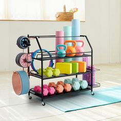 a rack filled with colorful toys on top of a white floor next to a blue rug