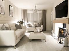 a living room filled with furniture and a flat screen tv mounted on the wall over a fire place