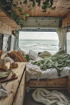 a bed sitting inside of a bedroom next to the ocean