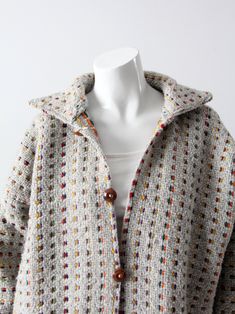 "This is a vintage boho woven knit jacket. The soft gray weave jacket has a rainbow square dot pattern. Wooden buttons detail the open front with a drawstring at the waist. Big patch pockets sit on the waist. A great beach coverup! CONDITION In good condition with wear consistent with age and use. Note: The buttons are decorative, as there are no button holes. MEASUREMENTS Bust: 48\" .. 121.9 cm Length: 27\" ... 68.6 cm Neck to Sleeve End: 31.5\" .. 80 cm 121113" Bohemian Multicolor Outerwear With Buttons, Multicolor Bohemian Outerwear With Buttons, Hippie Jacket, Open Jacket, Woven Jacket, Wooden Buttons, Dots Pattern, Knit Jacket, A Rainbow