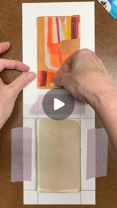 someone is cutting out an art piece with scissors and glue on the paper that has been cut into squares