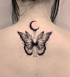 the back of a woman's neck with a butterfly and crescent tattoo on it