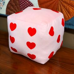 a red and white dice sitting on top of a wooden table