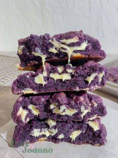 three purple cookies stacked on top of each other