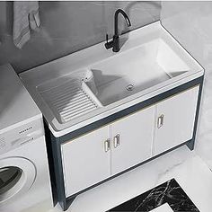 a white sink sitting next to a washer and dryer