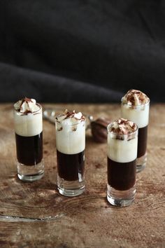 four shot glasses filled with ice cream and chocolate