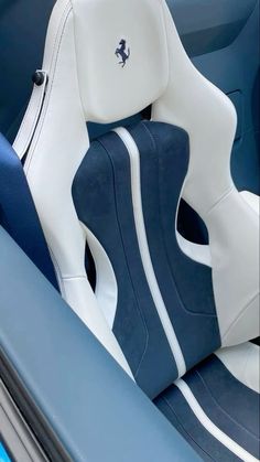 the interior of a blue and white sports car